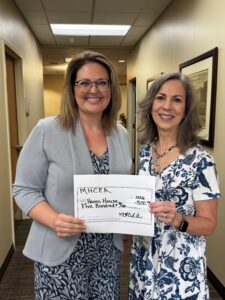 Photo of presentation of donation to Haven House.
